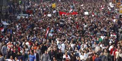 A crowd of demonstrators walks through Cairo on January 25, 2011, to demand the end of President Hosni Mubarak's nearly 30 years in power. [AP]