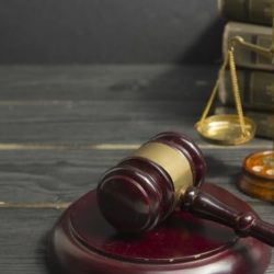 Legal Law concept - Open law book with a wooden judges gavel on table in a courtroom or law enforcement office. Copy space for text Legal Law concept - Open law book with a wooden judges gavel on table in a courtroom or law enforcement office. Copy space for text