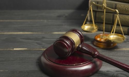 Legal Law concept - Open law book with a wooden judges gavel on table in a courtroom or law enforcement office. Copy space for text Legal Law concept - Open law book with a wooden judges gavel on table in a courtroom or law enforcement office. Copy space for text