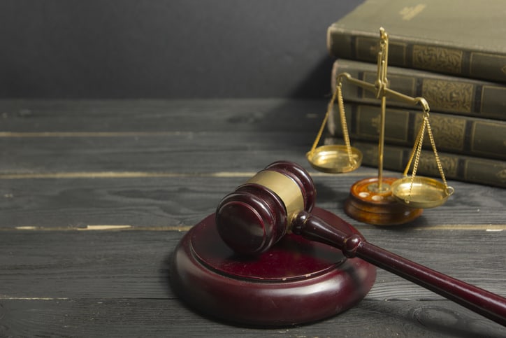 Legal Law concept - Open law book with a wooden judges gavel on table in a courtroom or law enforcement office. Copy space for text Legal Law concept - Open law book with a wooden judges gavel on table in a courtroom or law enforcement office. Copy space for text